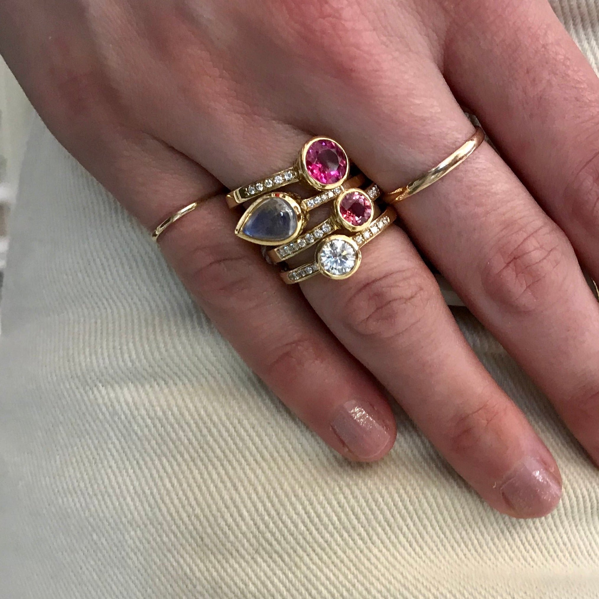 Diamond ring with bezel set shoulders