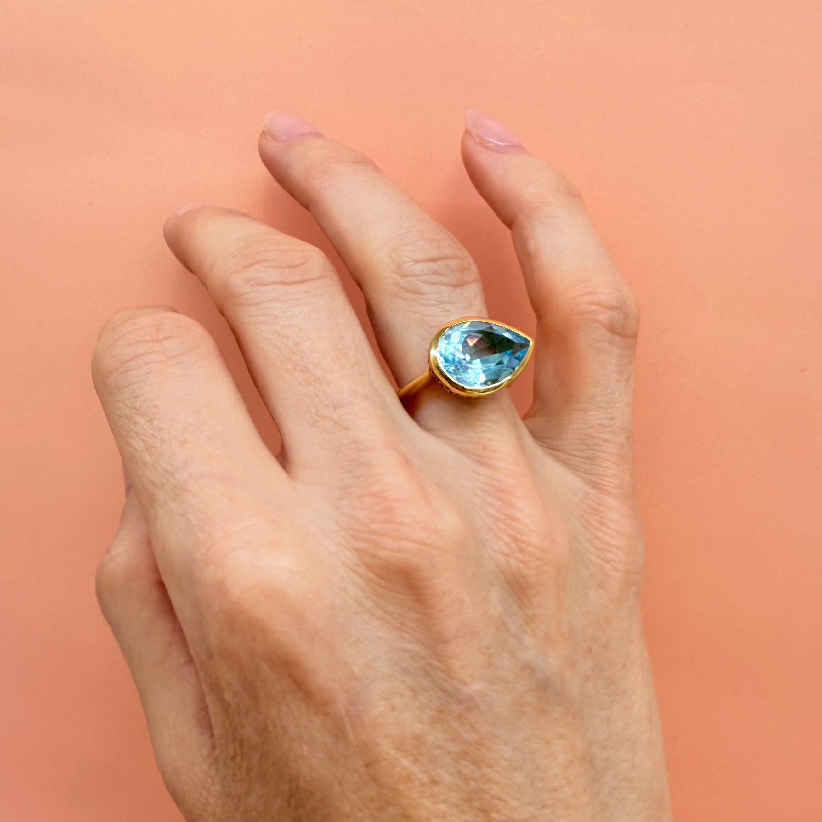 18K Yellow Gold Crownwork® Ring with East-West Pear Shaped Blue Topaz