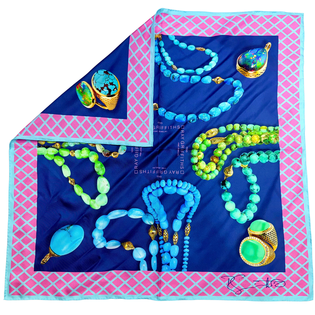 A square fashion scarf displayed flat with one corner folded over, featuring a navy blue center printed with turquoise and green beaded jewelry motifs, a pink diamond-pattern border, and a light blue edge.