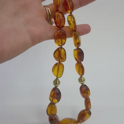 Video of a Baltic amber beads with preserved ancient insects, strung with gold clasp