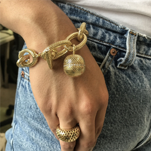 Photo of our large link gold bracelet with a gold ball charm and chunky ring