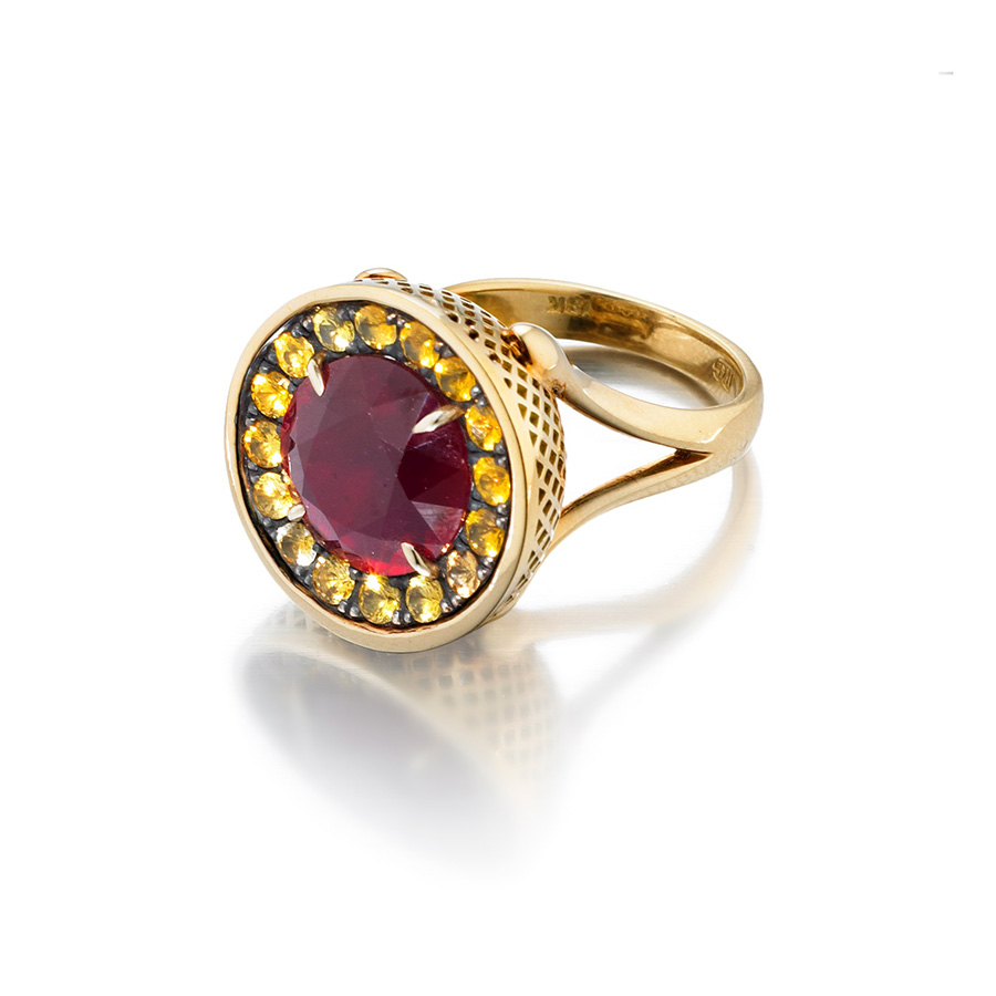 This is photo of a ruby cocktail ring with yellow sapphire surround 