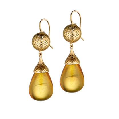 This picture shows amber drop earrings hanging off 18k yellow gold balls