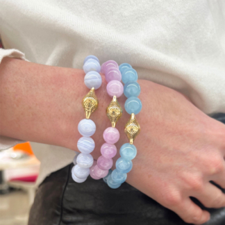 This image shows the blue lace agate beaded bracelet layered with aquamarine and kunzite