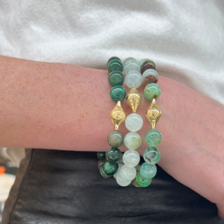 This image shows our emerald stretch bracelet layered with green beryl beads and chrysoprase beads