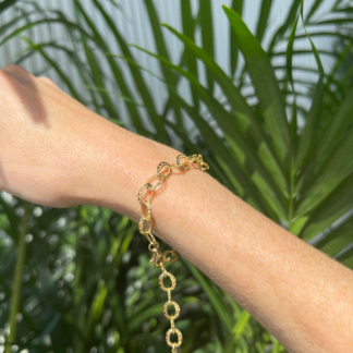 this is a gold crownwork bracelet modeled on hand