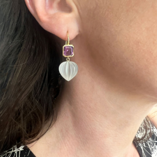this is an amethyst earring with frosted quartz drop modeled on ear
