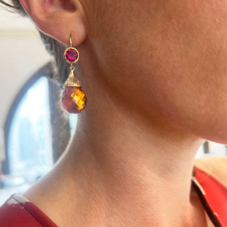 This is a garnet earring with amber drop modeled on ear