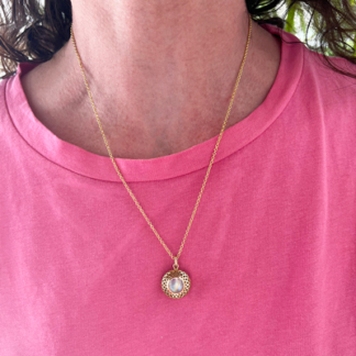 This is an image of our moonstone pillow top pendant necklace being worn