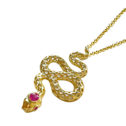 This is an image of a snake pendant with a pink sapphire head and eyes on a chain