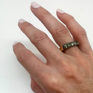 This is an image of our green sapphire stacker band worn on the ring finger