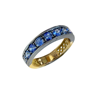 This is a product image of a stacker band with pave set sapphires in oxidized silver and a yellow gold band