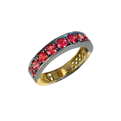 This is a product image of a red sapphire stacker band with stones set in oxidized silver and a yellow gold band