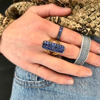 This is an image of a blue sapphire band and larger pave sapphire ring