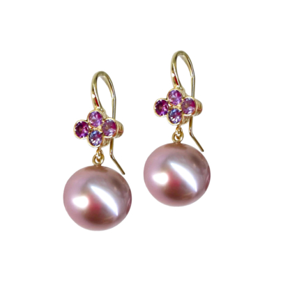 This is a pearl drop earring with 4 pink sapphires set in a clover on the yellow gold hook
