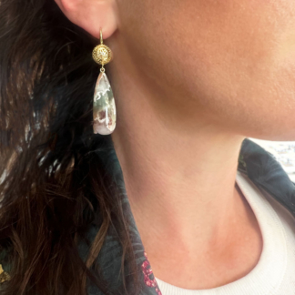 This is a photo of Aquaprase drop earrings with 18k Yellow Gold Crownwork tops worn on the ear