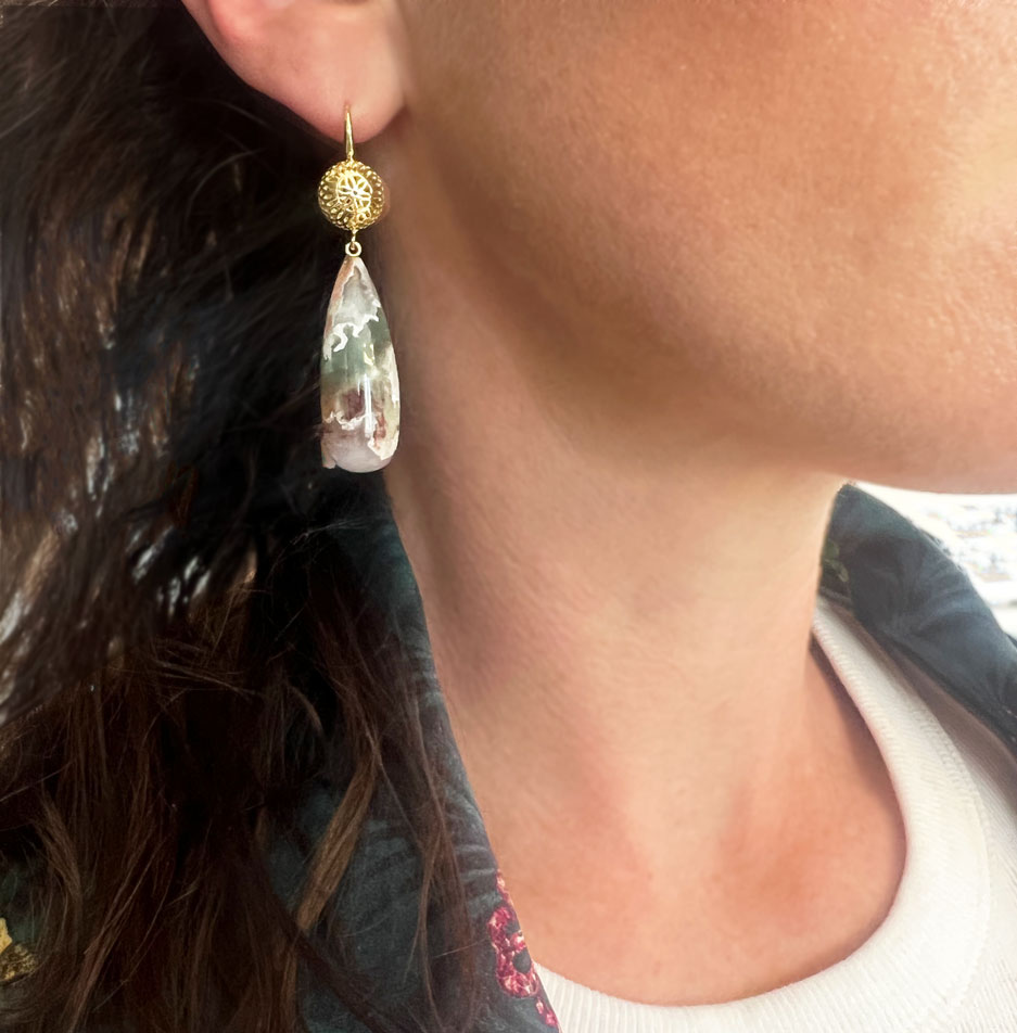 This is a photo of Aquaprase drop earrings with 18k Yellow Gold Crownwork tops worn on the ear