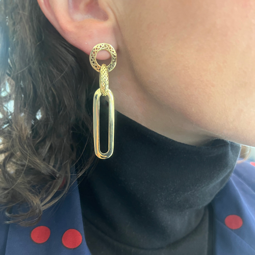 This is an image of a pair of 18k Yellow Gold mixed link earrings being worn by a brunette model