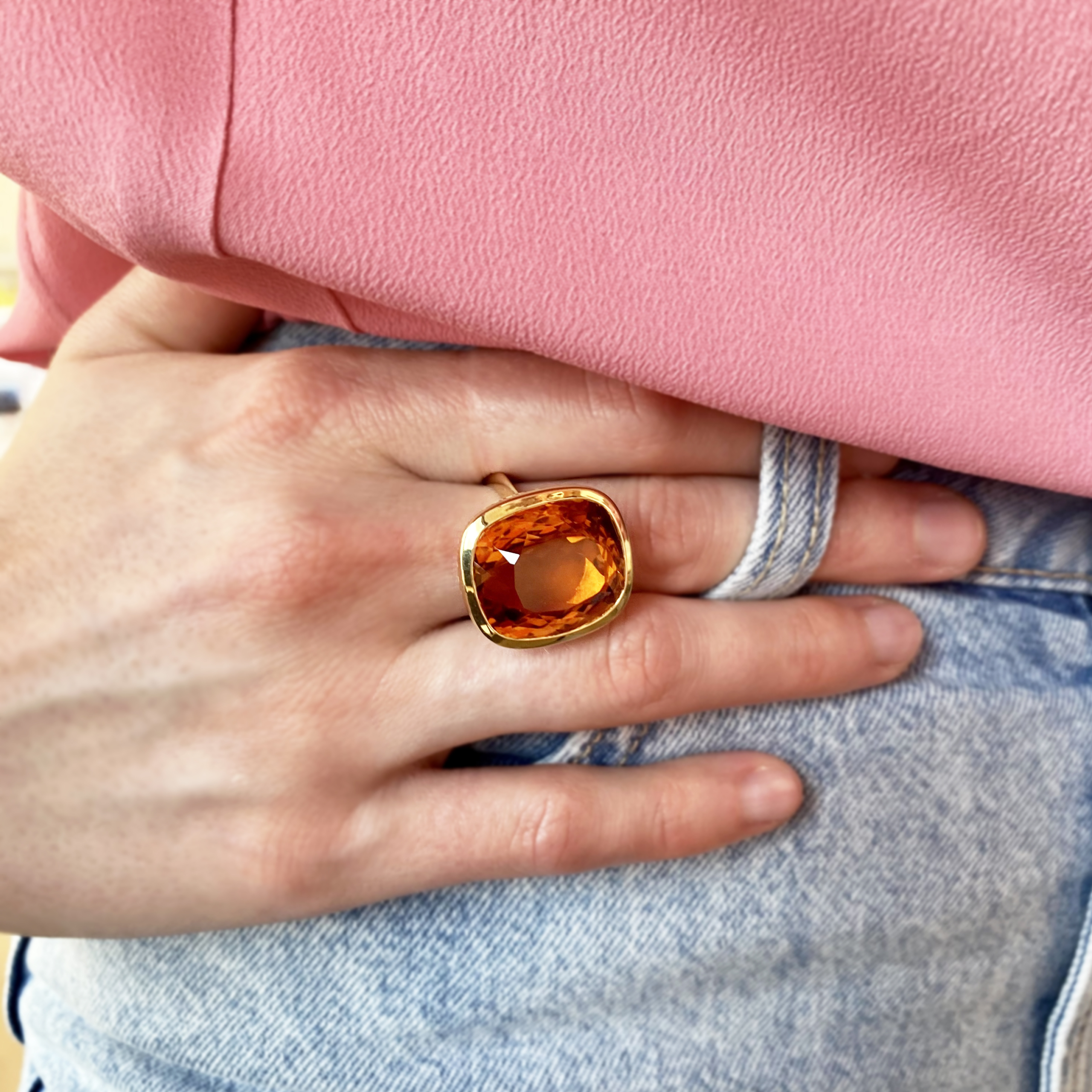 This is a photo of an 18K yellow gold Crownwork cocktail ring with large Madeira Citrine worn on the finger