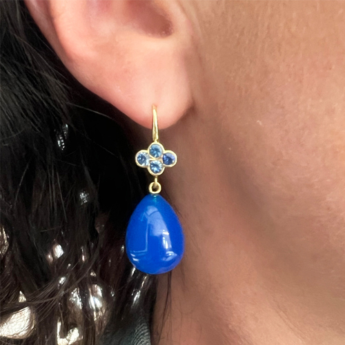 This is a shot of our bright blue earrings featuring sapphires and bright blue agate drops being worn