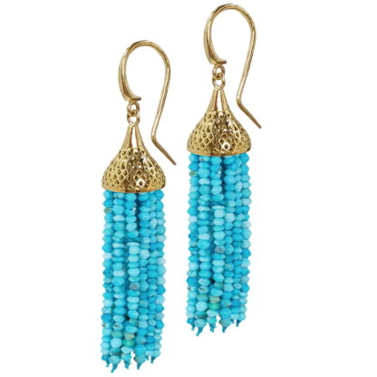 This is a photo of a pair of turquoise tassel drop earrings with a gold top on wires