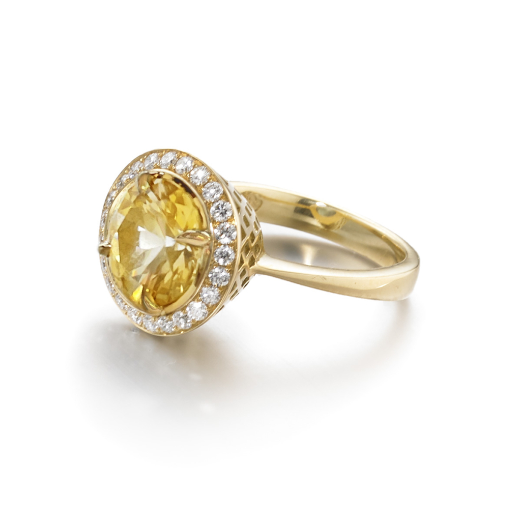 This is a photo of an 18k yellow gold 10mm Crownwork bezel set Yellow Sapphire ring with pave diamond surround