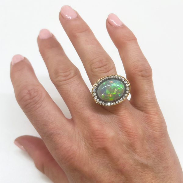 This is a shot of our opal and diamond ring being worn on the ring finger