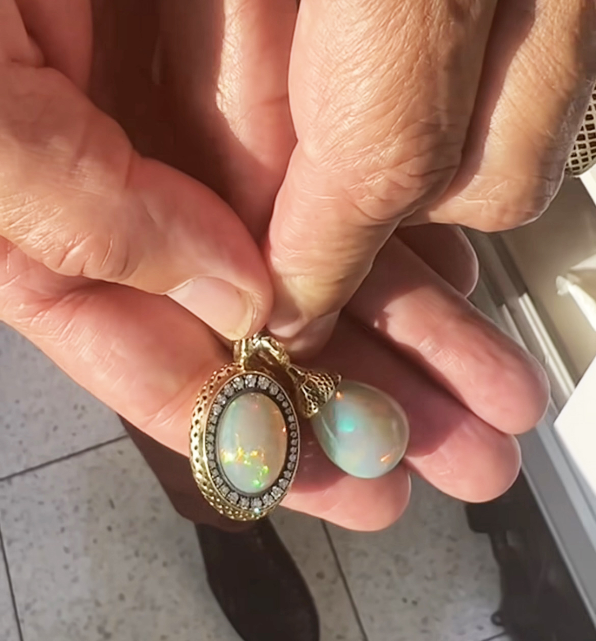 This is a photo of two opal pendants