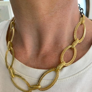 This is a 18k Yellow Gold Crownwork disc link chain with oxidized silver chain worn with a white T-shirt