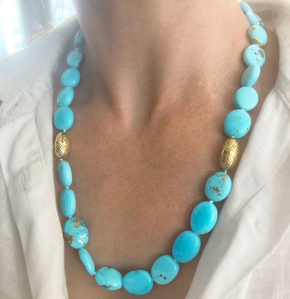 This is a photo of a Sonoran Turquoise Necklace with two medium 18k yellow gold olive beads