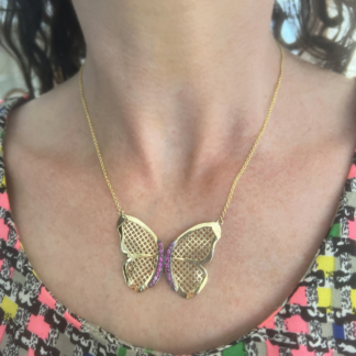 This is a photo of a gold chain necklace with Crownwork Butterfly with pave pink sapphires.