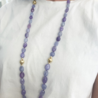 This is a Hackmanite beaded necklace with two small Crownwork finials and two amphoras on ozidized silver chain and lilypad clasp worn with a white T-Shirt