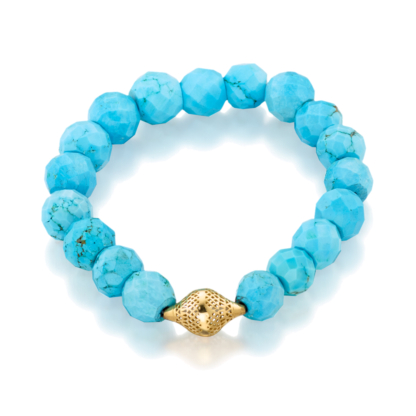 This is a photo of a facteted turquoise stretch bracelet with a small 18k gold finial