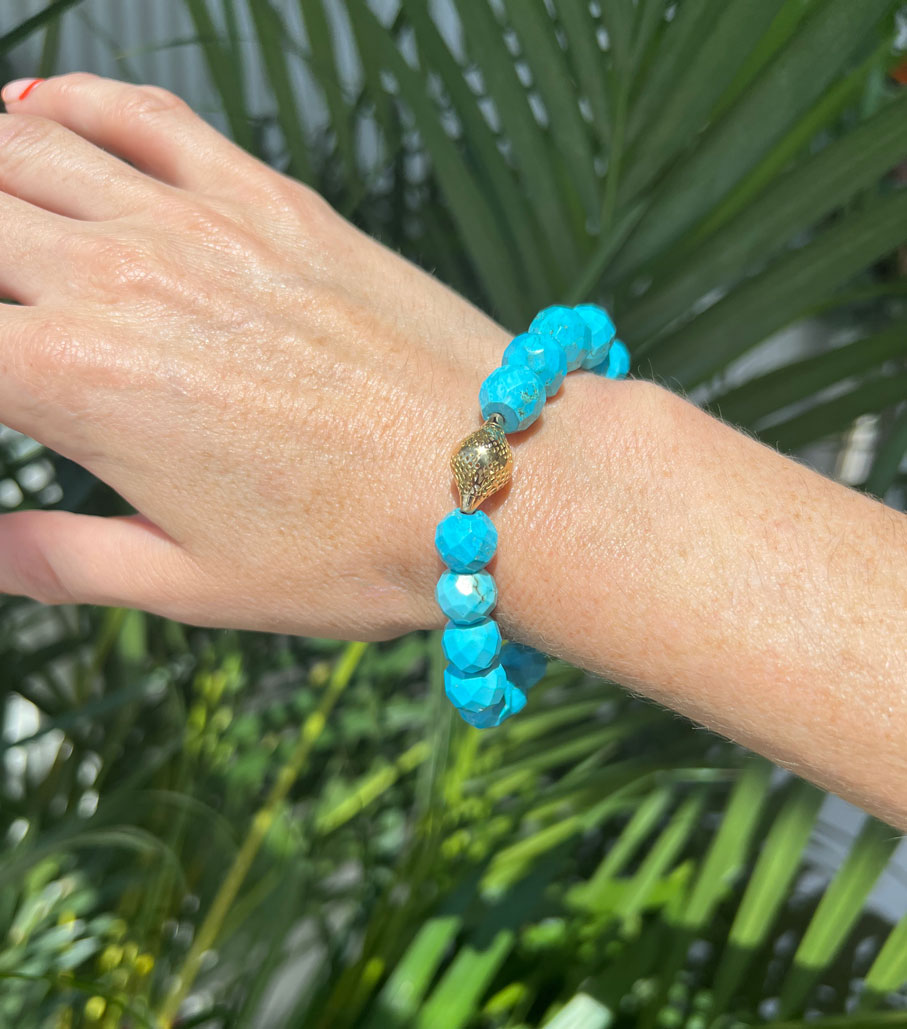 This is a photo of the faceted turquoise stretch bracelet being worn on the wrist