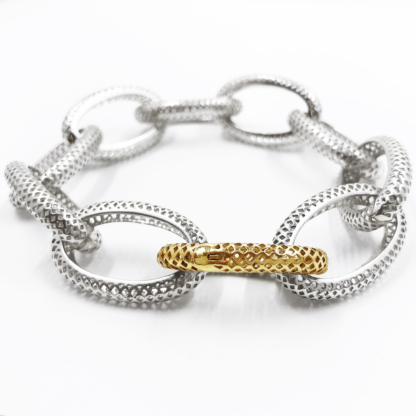 This is a product shot of a polished silver and crownwork link bracelet