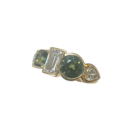 This is a product image of a scalloped crownwork set green sapphire and diamond ring in 18k Yellow Gold